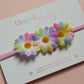 Pink baby headband with 3 multicolour daisy flowers