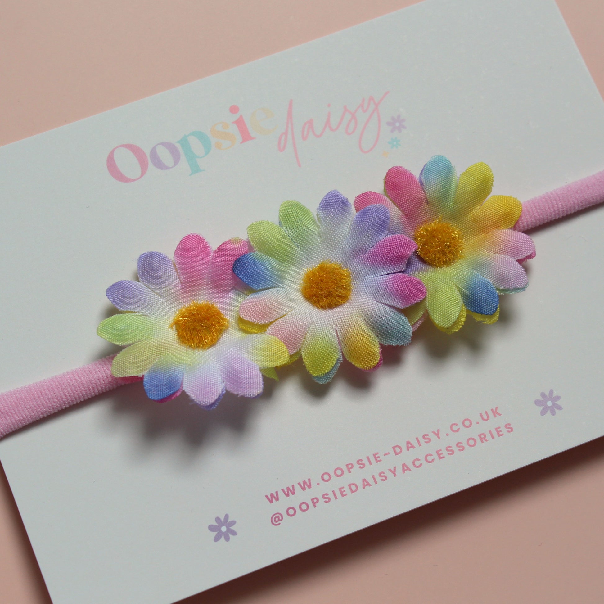 Pink baby headband with 3 multicolour daisy flowers