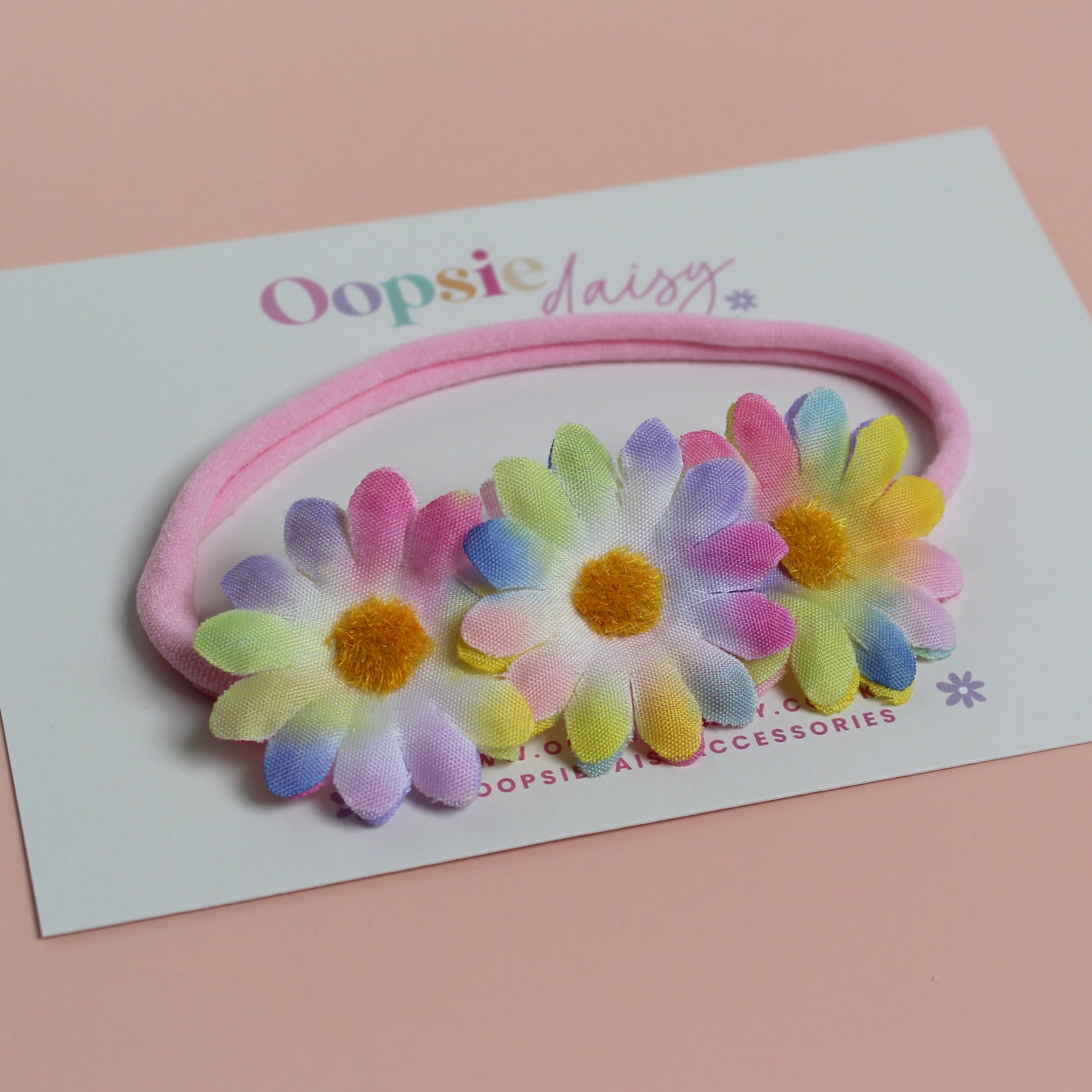 Pink baby headband with 3 multicolour daisy flowers