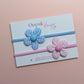 2 baby headbands in blue and pink with gingham flower