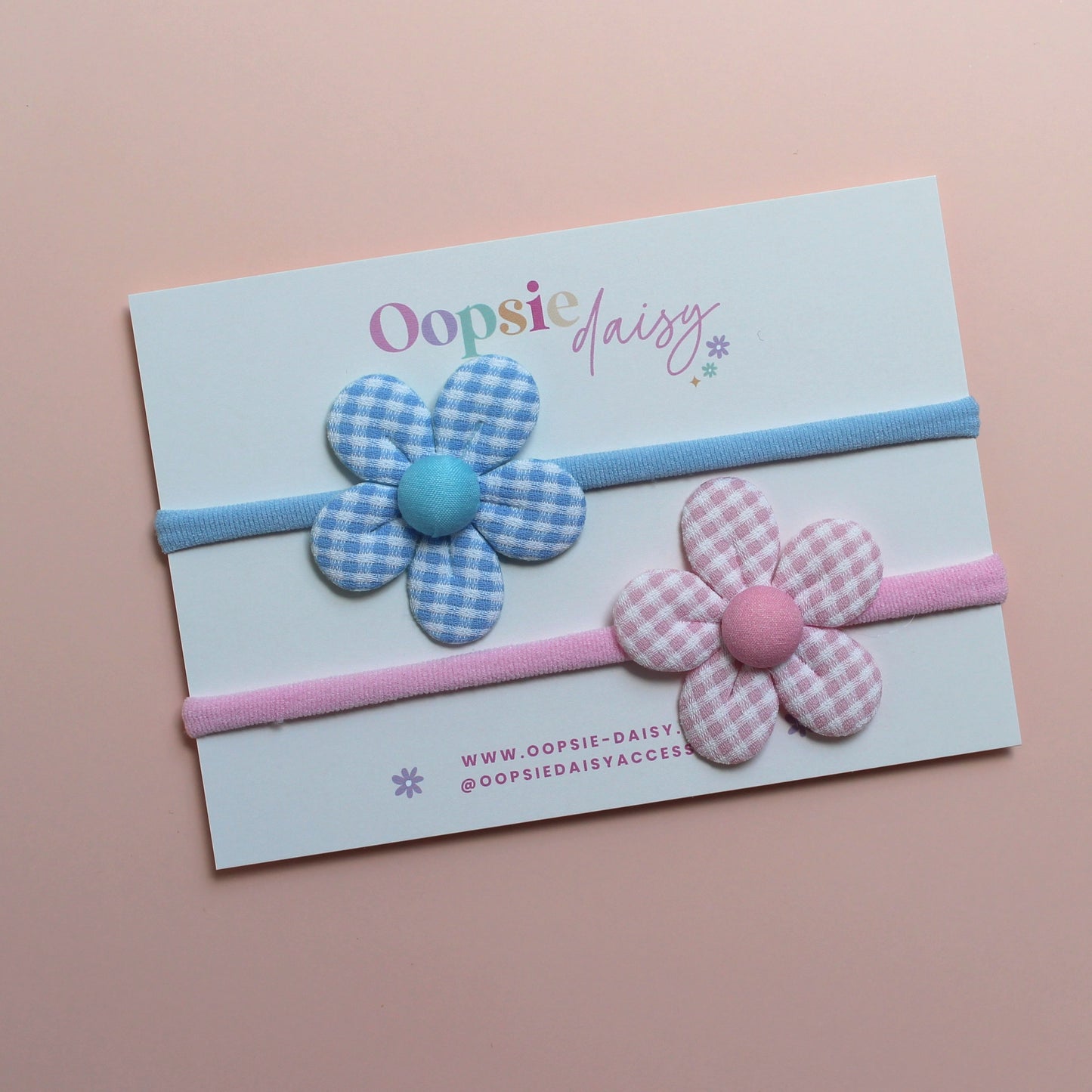 2 baby headbands in blue and pink with gingham flower