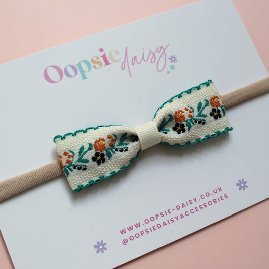 Baby headband with cream and green floral bow