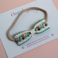 Baby headband with cream and green floral bow