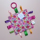 Sensory crinkle tag toy with pink floral pattern