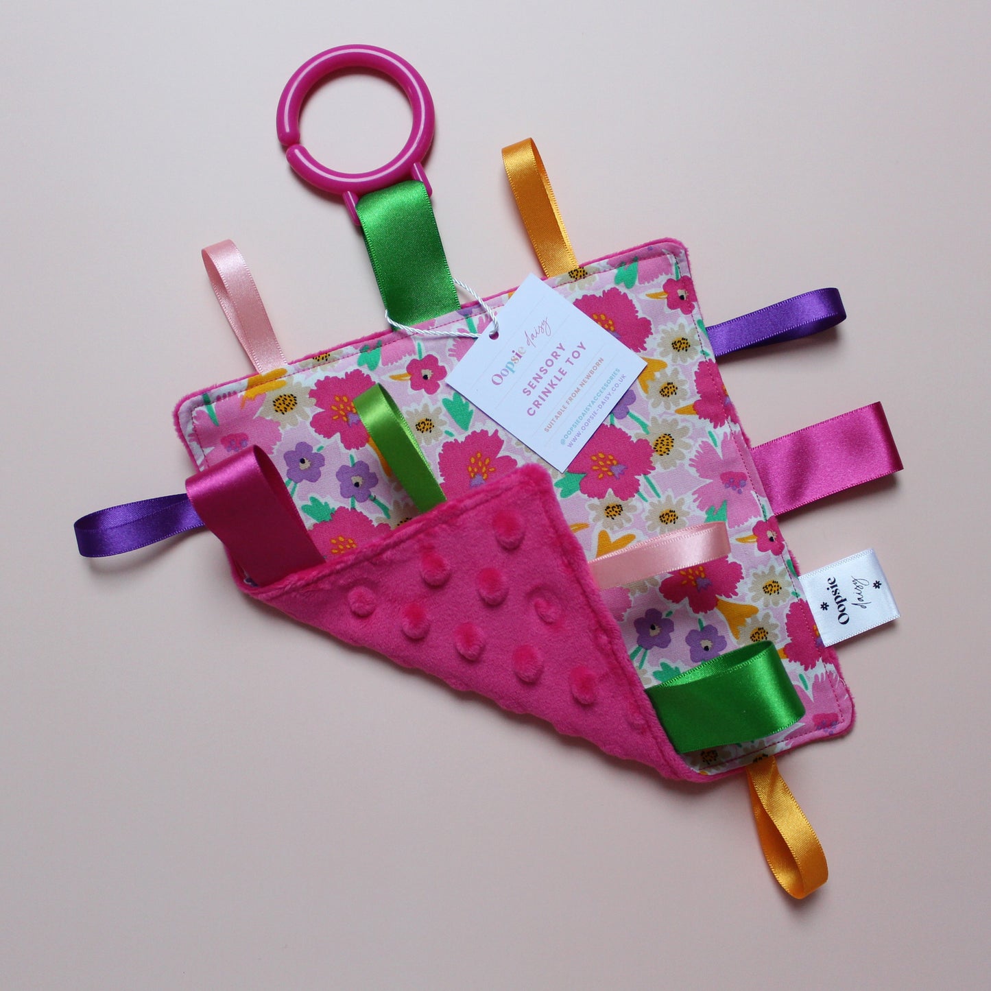 Sensory crinkle tag toy with pink floral pattern