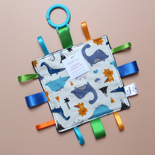 Sensory crinkle tag baby toy with dinosaur pattern