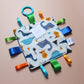 Sensory crinkle tag baby toy with dinosaur pattern