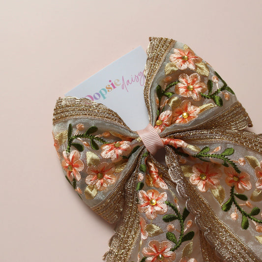 Embroidered floral hair bow with peach and rose gold shimmer