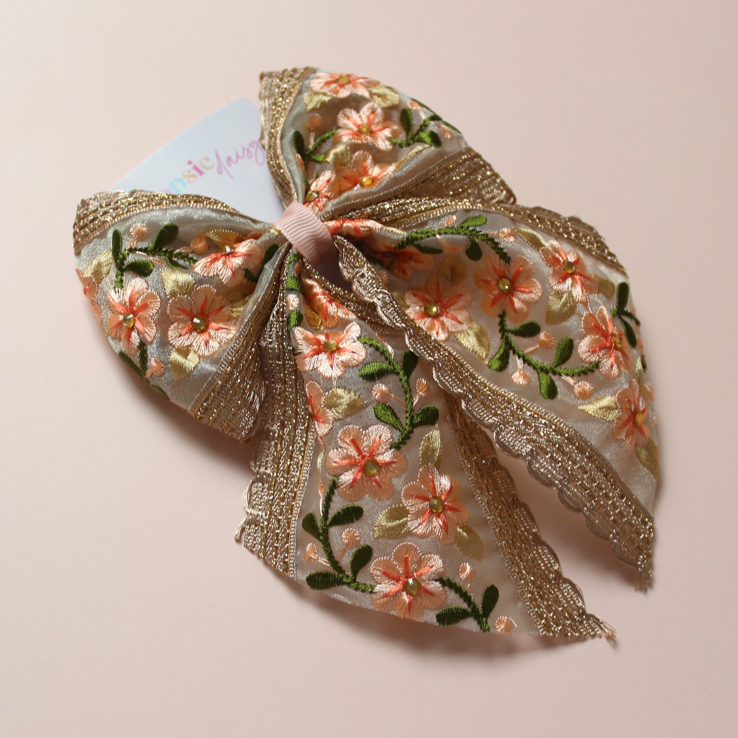 Embroidered floral hair bow with peach and rose gold shimmer