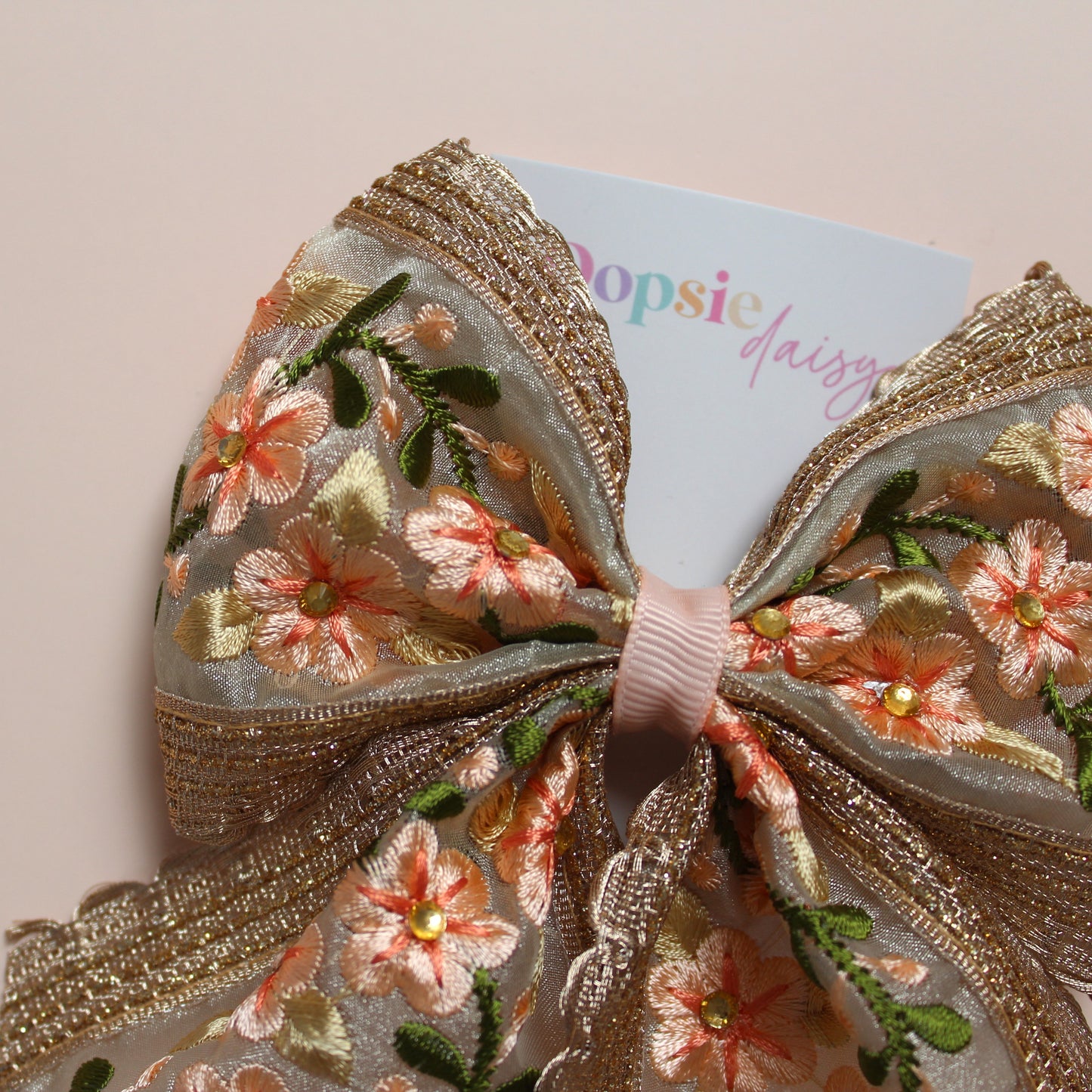 Embroidered floral hair bow with peach and rose gold shimmer