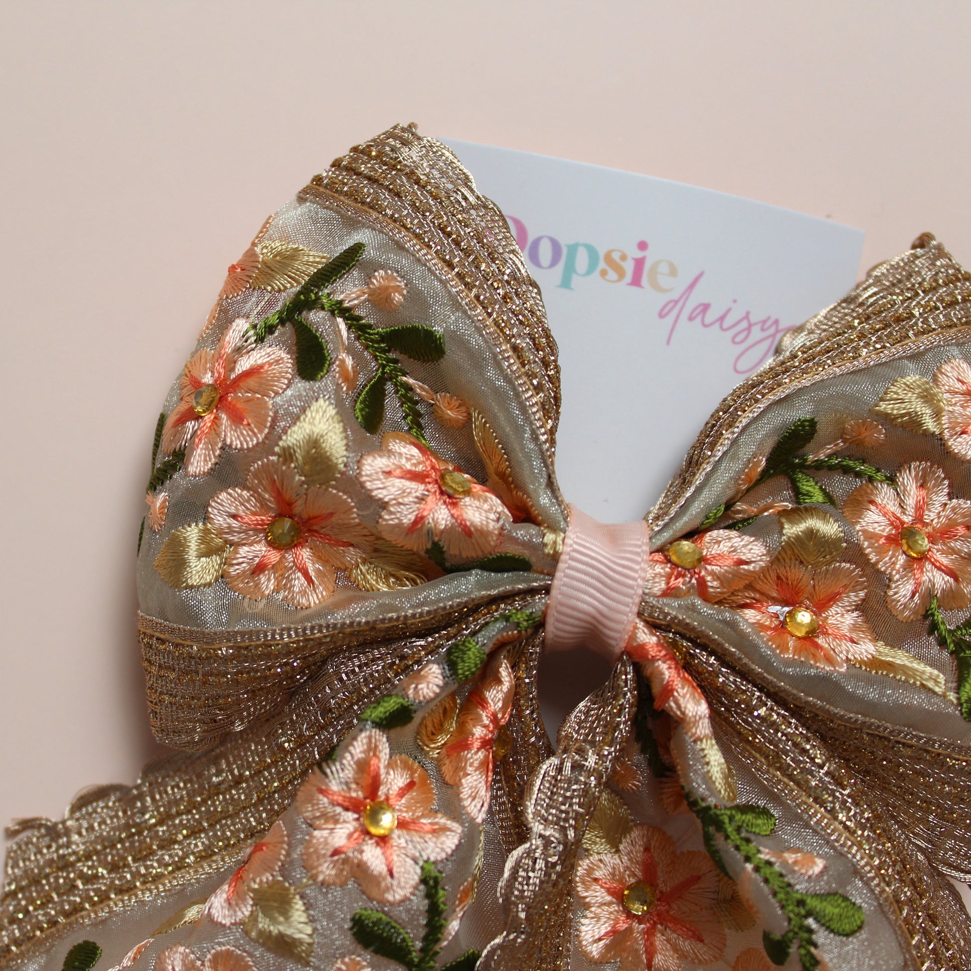 Embroidered floral hair bow with peach and rose gold shimmer