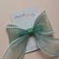 Green organza hair bow with pearls