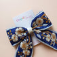 Blue and white embroidered hair bow with floral pattern