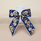 Blue and white embroidered hair bow with floral pattern