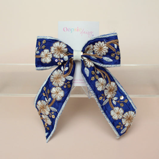 Blue and white embroidered hair bow with floral pattern